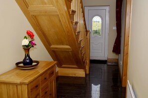 A wooden staircase leading to a door with a glass window.