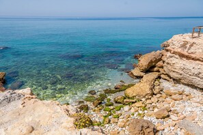 On the beach, sun-loungers