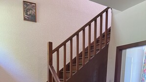 A wooden staircase with a handrail, leading to a room with a tiled shower area. - The Maid's House, Carmichael Country Cottages. 4 star comfortable cottage on rural Estate (Biggar)