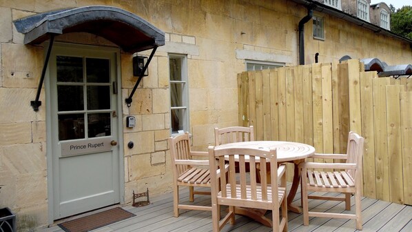 A wooden door labeled "Prince Rupert" with a small porch and a wooden fence.