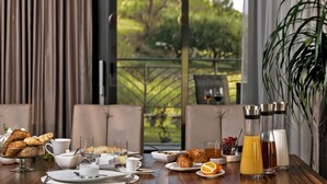 A breakfast setting with croissants, coffee, juice, and milk.