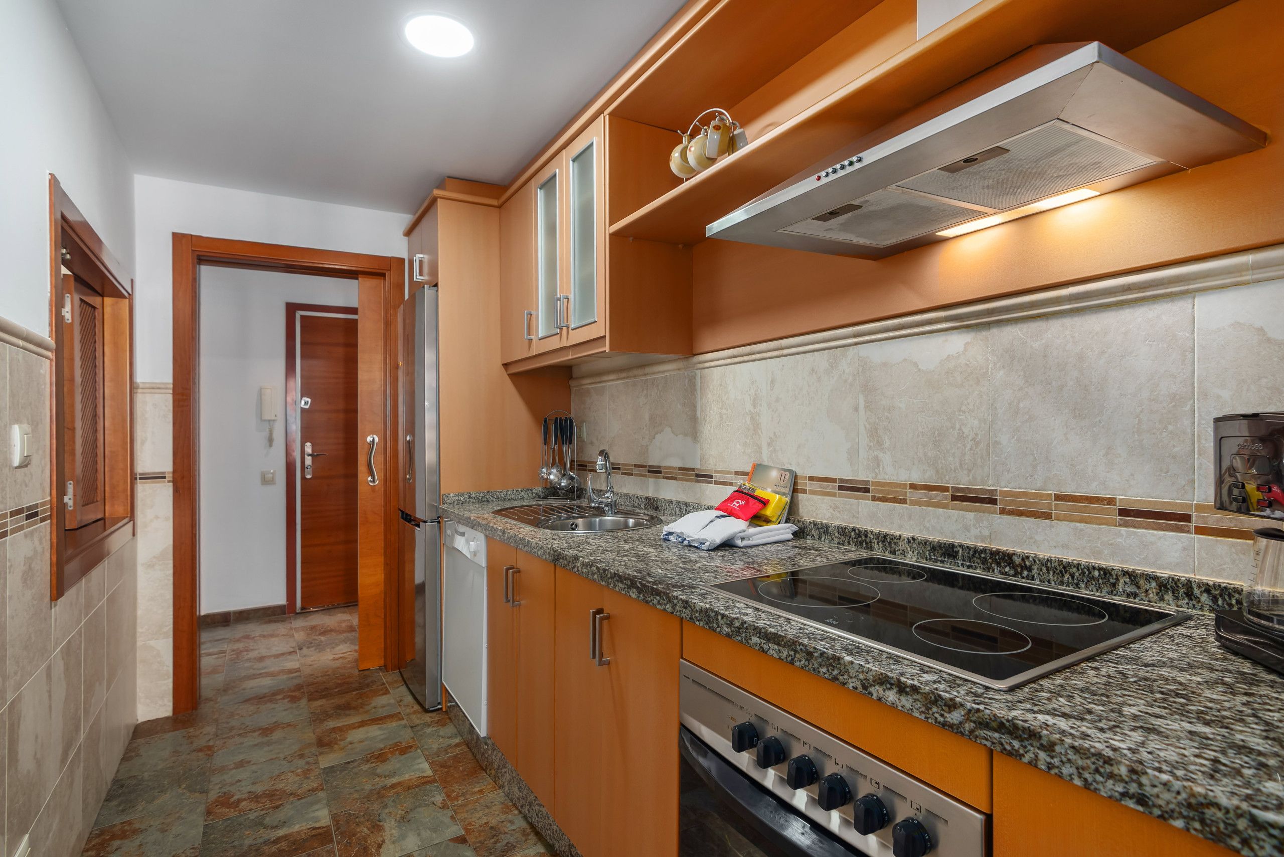 Una cocina con estufa, horno y microondas.