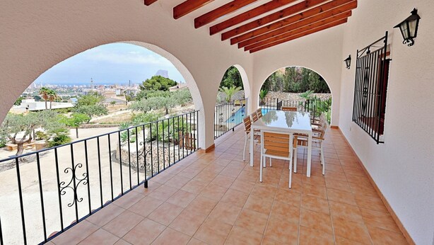 A balcony with a table and chairs, a view of the city, and a pergola structure. - Laura-29A - pretty holiday property with garden and private pool in Calpe (Calpe)