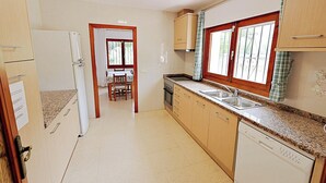 A kitchen with a refrigerator, oven, dishwasher, and granite countertop. - Laura-29A - pretty holiday property with garden and private pool in Calpe (Calpe)