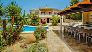 A villa with a swimming pool, outdoor seating, and a patio area. - Nessa - well furnished villa with panoramic views in Benitachell (Benitachell)