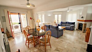 A spacious living room with a dining area, a fireplace, and a view of the outdoors. - Nessa - well furnished villa with panoramic views in Benitachell (Benitachell)