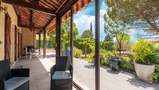 An outdoor patio with wicker furniture, a grill, and potted plants. - Villa in Callian with Heated Pool and Terrace (Callian)