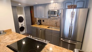 Enjoy cooking in this well-equipped kitchen with a refrigerator, microwave, dishwasher, oven, and stovetop.