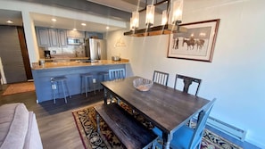 Enjoy meals at the dining table, set with a bowl, surrounded by comfortable chairs.