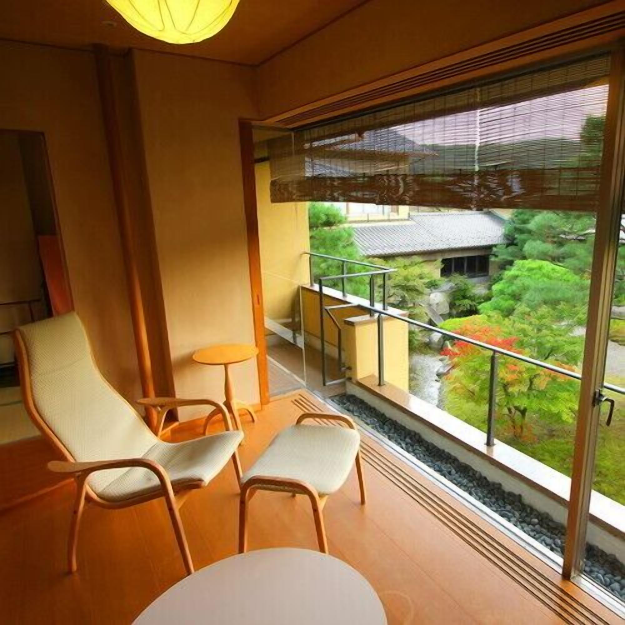 A balcony with a view of a traditional building and greenery.