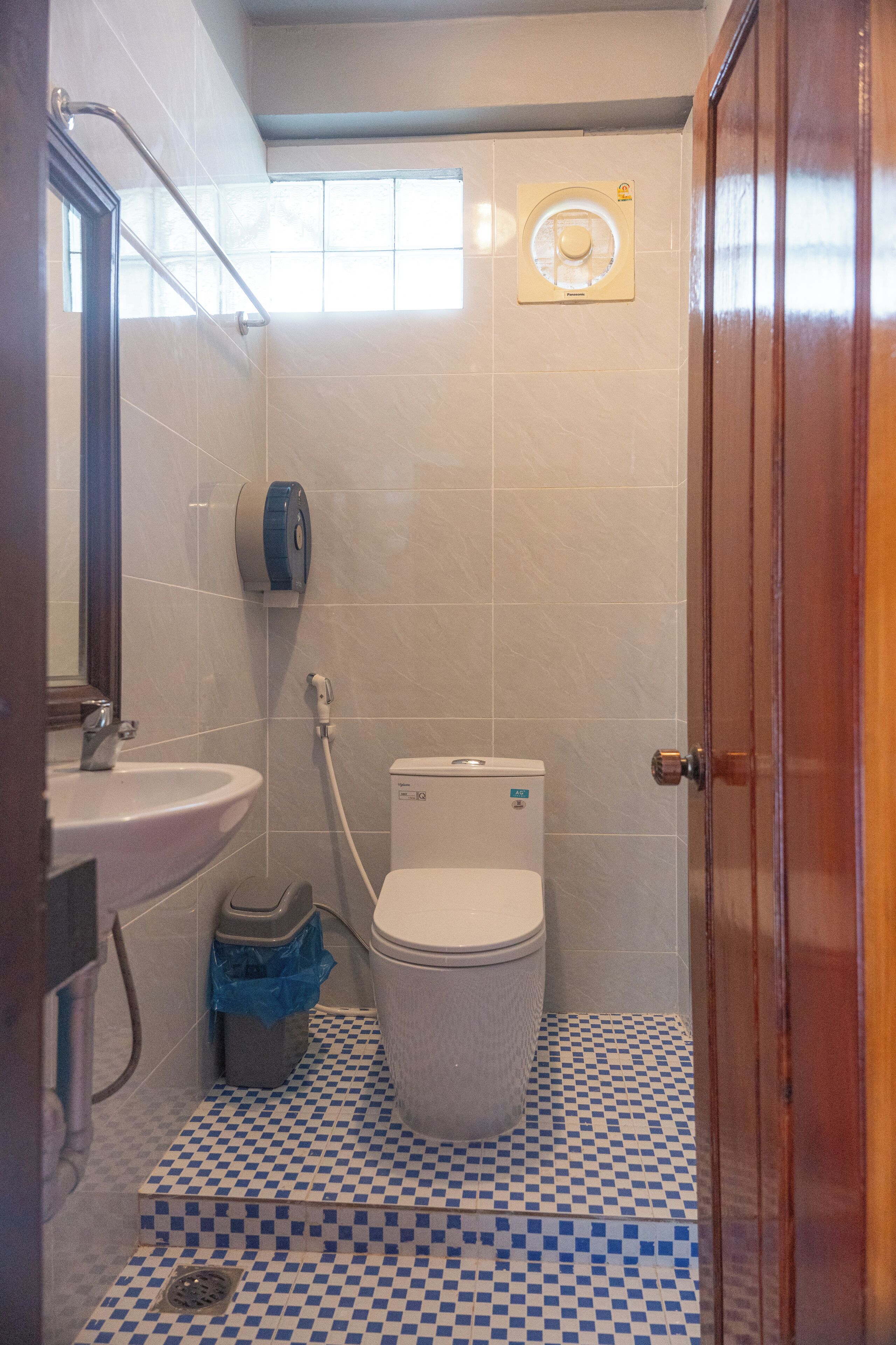 A small bathroom with a sink, toilet, and a shower.
