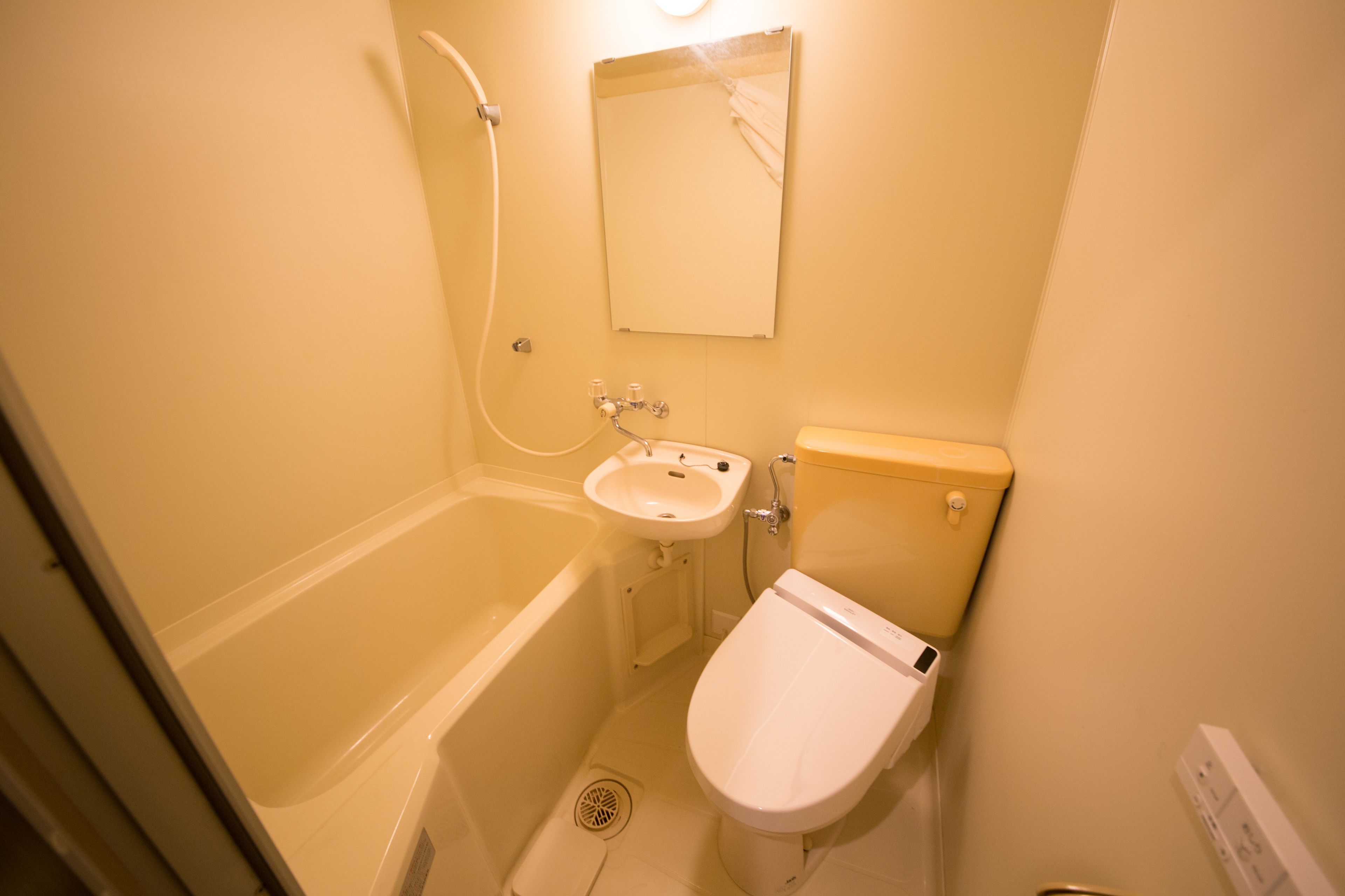 A small bathroom with a bathtub, a sink, and a toilet.