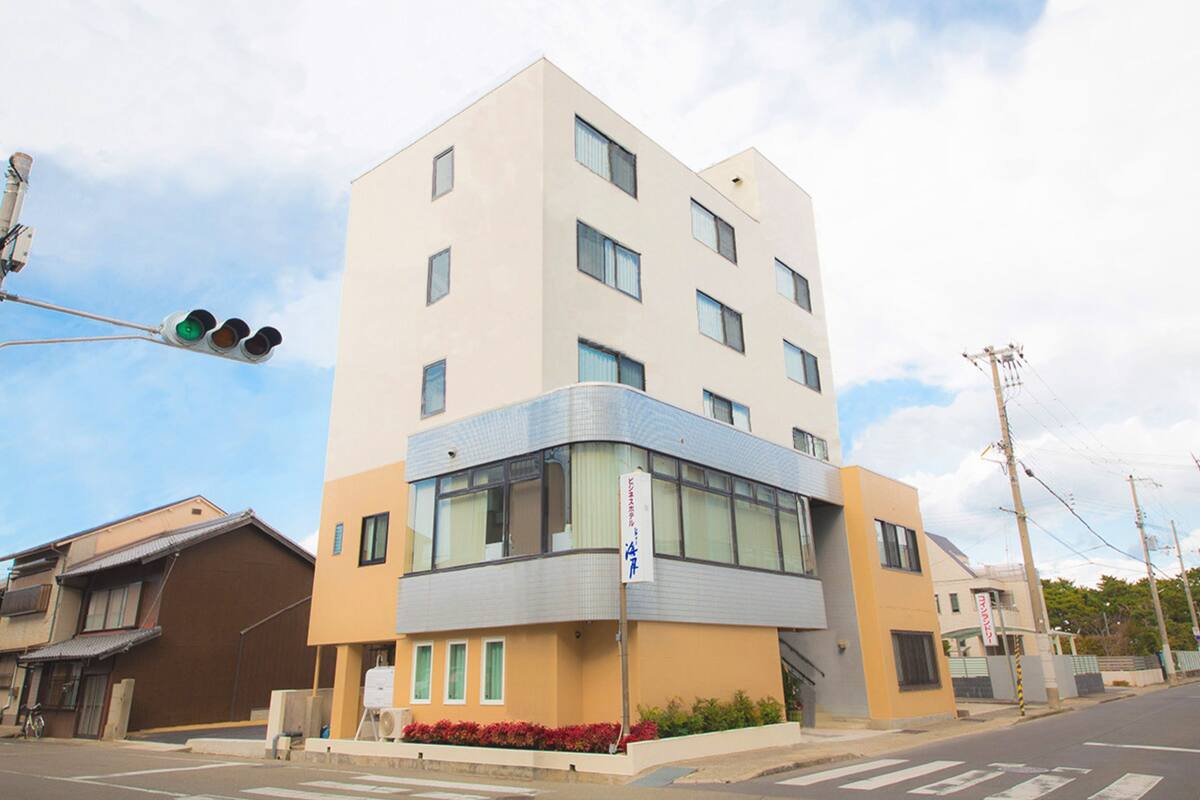 A multi-story building with a modern design, featuring a mix of glass and concrete facades.