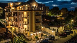 A multi-story hotel with balconies, a parking area, and a view of the surrounding neighborhood. - Family Hotel Sirena Palace (Obzor)