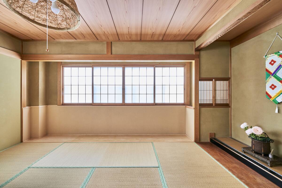 Une pièce de style japonais traditionnel, avec des tatamis, un paravent shoji et une porte shoji suspendue.