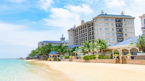 A beachfront hotel with multiple floors, balconies, and a pool area. - Lan Rung Beach Resort (Ho Chi Minh City)