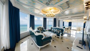 A luxurious room with a view of the ocean, featuring elegant furniture and a chandelier. - Lan Rung Beach Resort (Ho Chi Minh City)