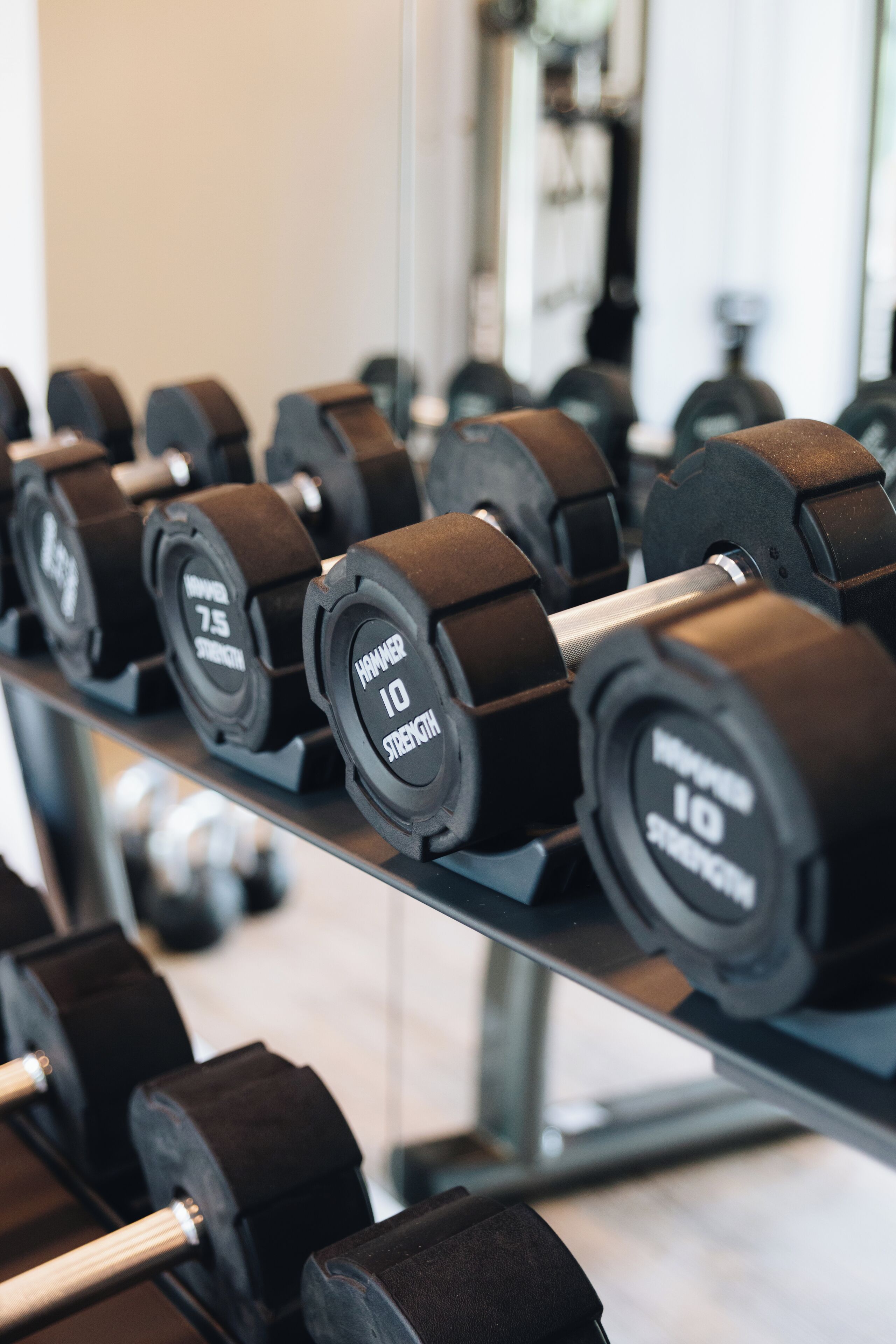 A rack of dumbbells with weights labeled 10 and 75.