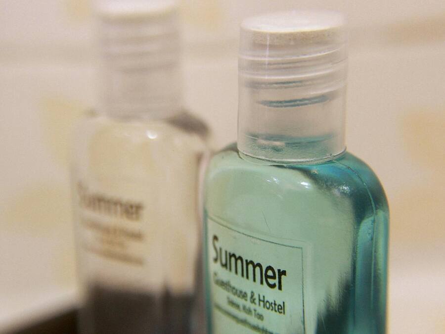 Dos botellas con etiqueta que dice "Summer" e indicación de "Greenhouse & Hostel".