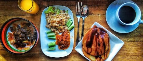 A meal tray with rice, vegetables, a bowl of soup, and a plate of meat.