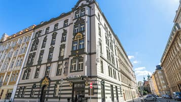 Un edificio histórico con un estilo arquitectónico clásico, que destaca por su entrada principal con un arco decorativo y un cartel que indica el nombre 'CARUSO'.
