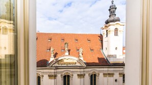 A building with a red-tiled roof and classical architecture, including statues and columns. - Hotel Caruso Old Town Prague (Prague)