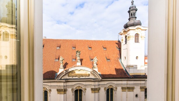 A building with a red-tiled roof and classical architecture, including statues and columns. - Hotel Caruso Old Town Prague (Prague)