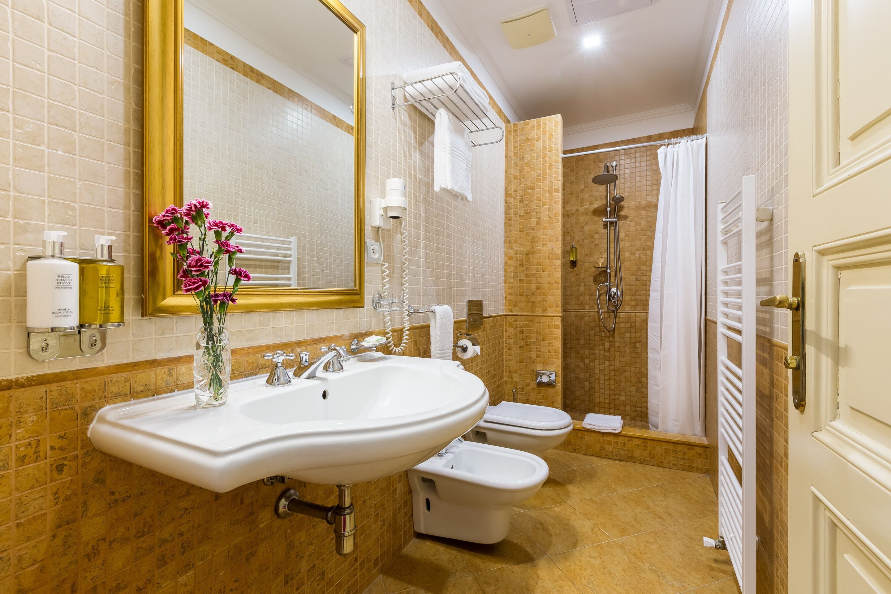 designer toiletries, hair dryer, slippers, bidet