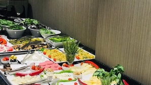 A buffet with various food items and condiments. - Yeni Bahar Otel (Ankara)