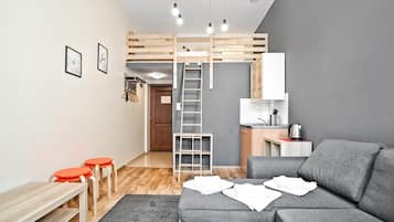 Deluxe Studio Suite | Living area | 30-inch flat-screen TV with cable channels, TV