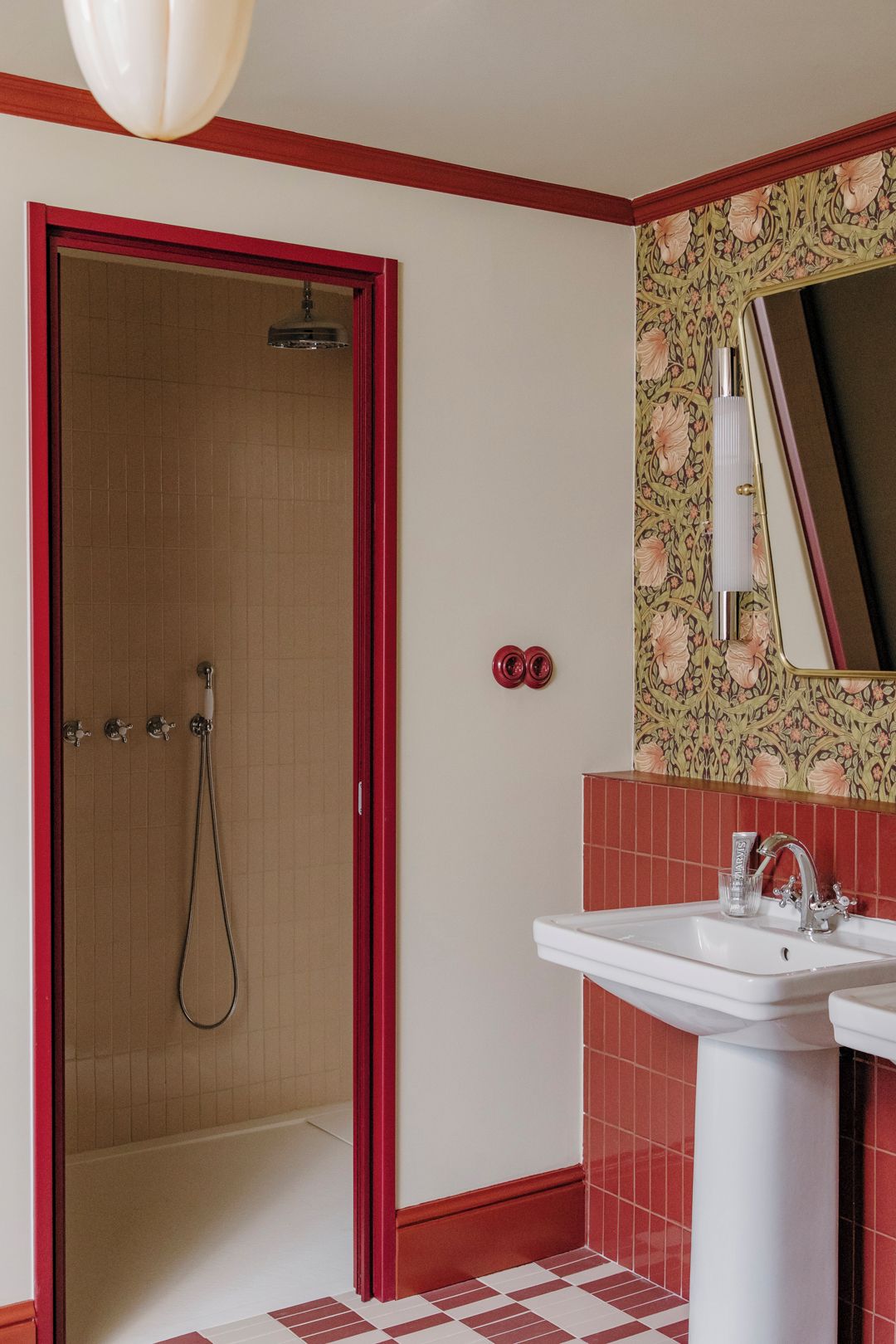 A bathroom with a shower, a sink, and a mirror.