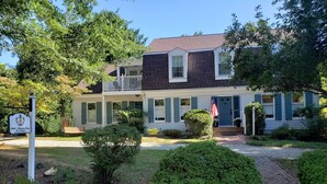 A two-story house with a porch, a small garden, and a mailbox. - Miller-Dunham House Bed & Breakfast (Odessa)