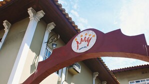 A building entrance with a sign that reads "MAY."