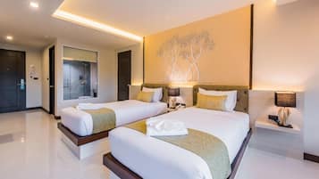 A hotel room with two beds, a large wall art piece, and a modern bathroom visible through a glass door.