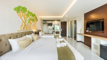 A modern hotel room with a large bed, a flat-screen TV, and a wall-mounted TV.