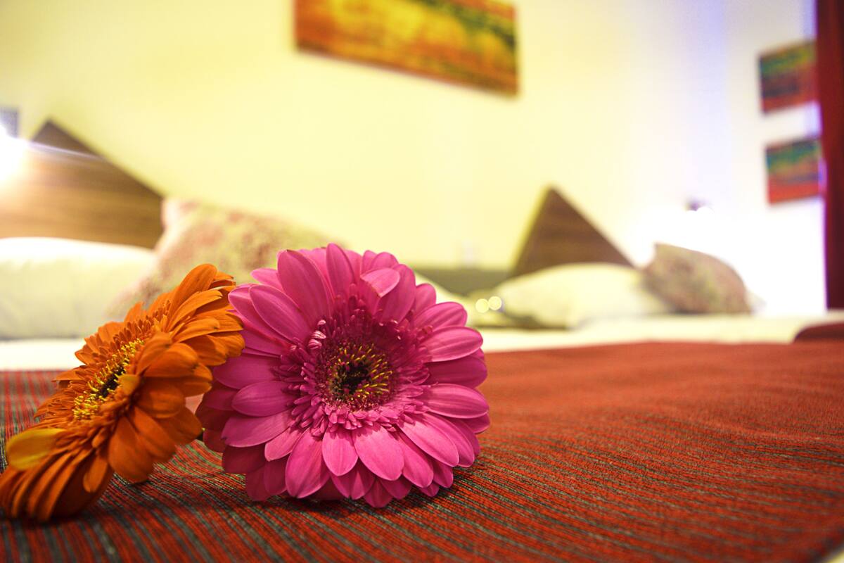 A bed with pillows and a blanket.