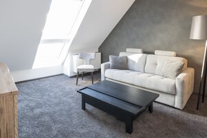 Suite, 1 King Bed with Sofa bed, Kitchenette | Living area | 43-inch flat-screen TV with satellite channels, TV, iPod dock