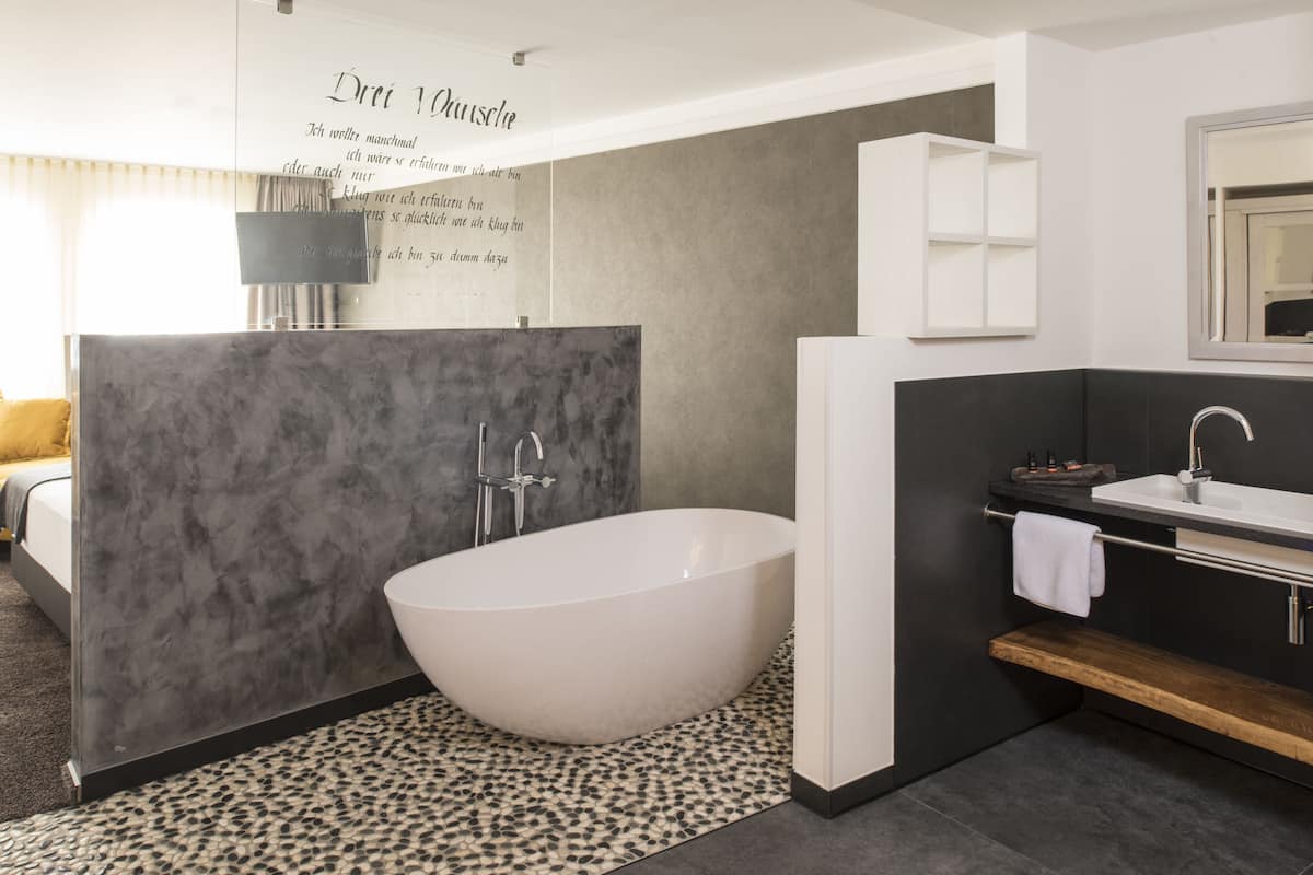 superior double room | bathroom | deep-soaking bathtub, free toiletries, hair dryer, bathrobes