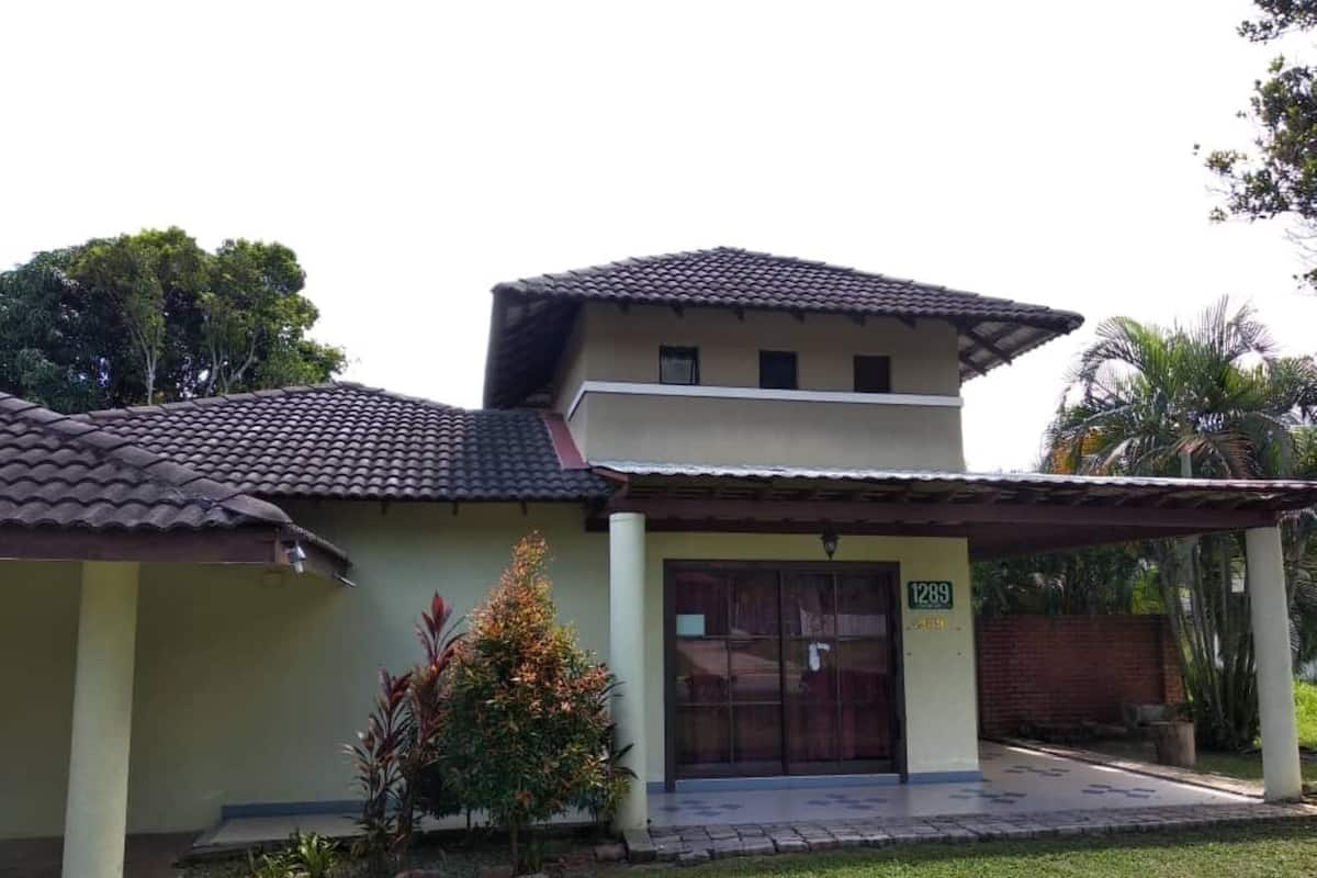 A two-story building with a tiled roof and a number 1289 sign.