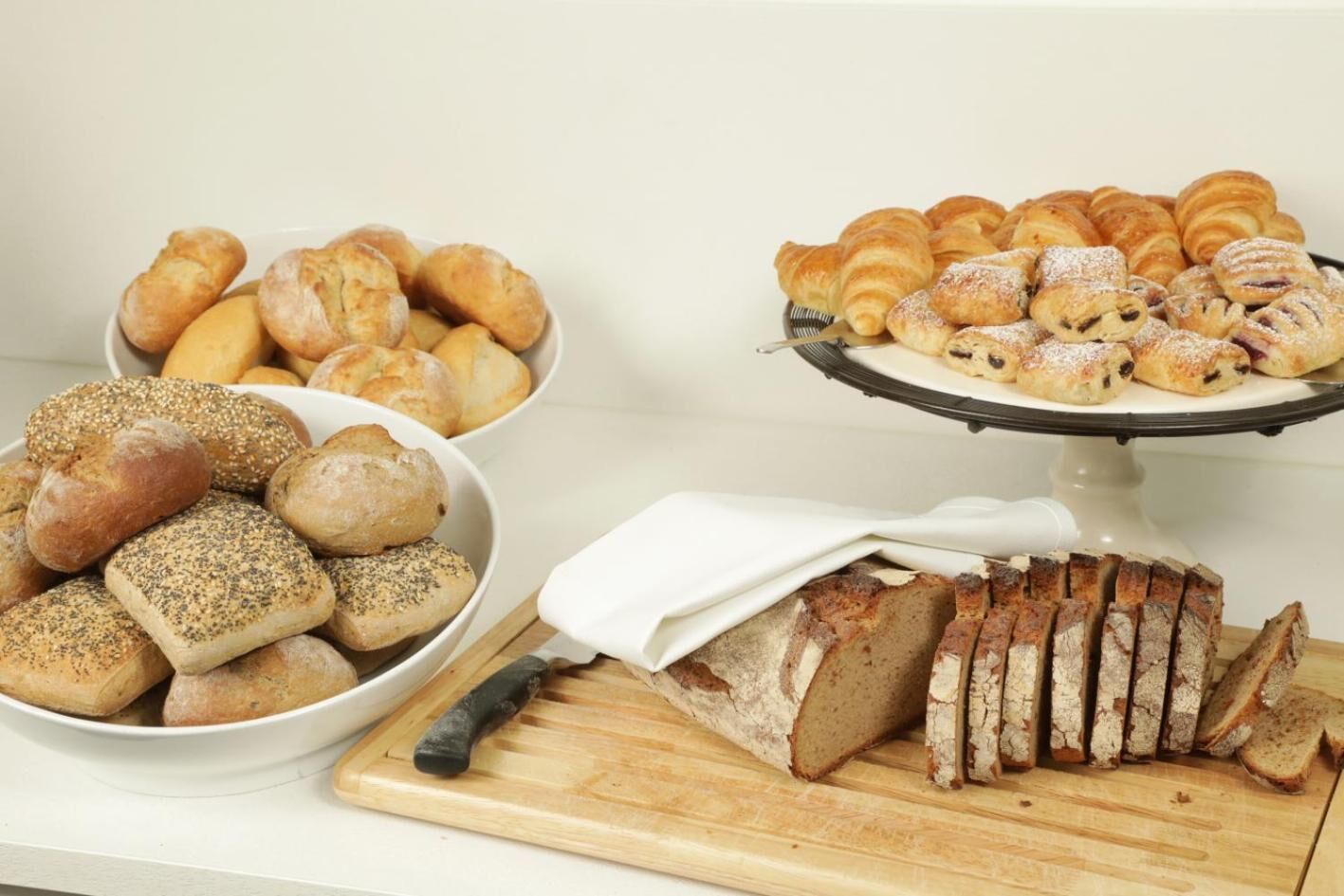 A variety of breads and pastries on a table.