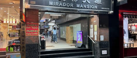 A hotel entrance with a sign reading 'MIRADOR MANSION.'