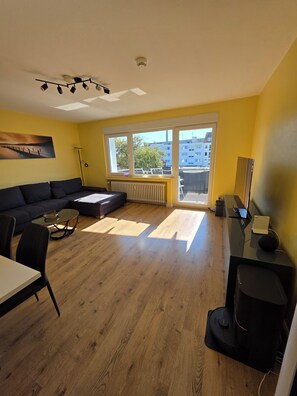 Deluxe Apartment | Living room | Flat-screen TV, Netflix