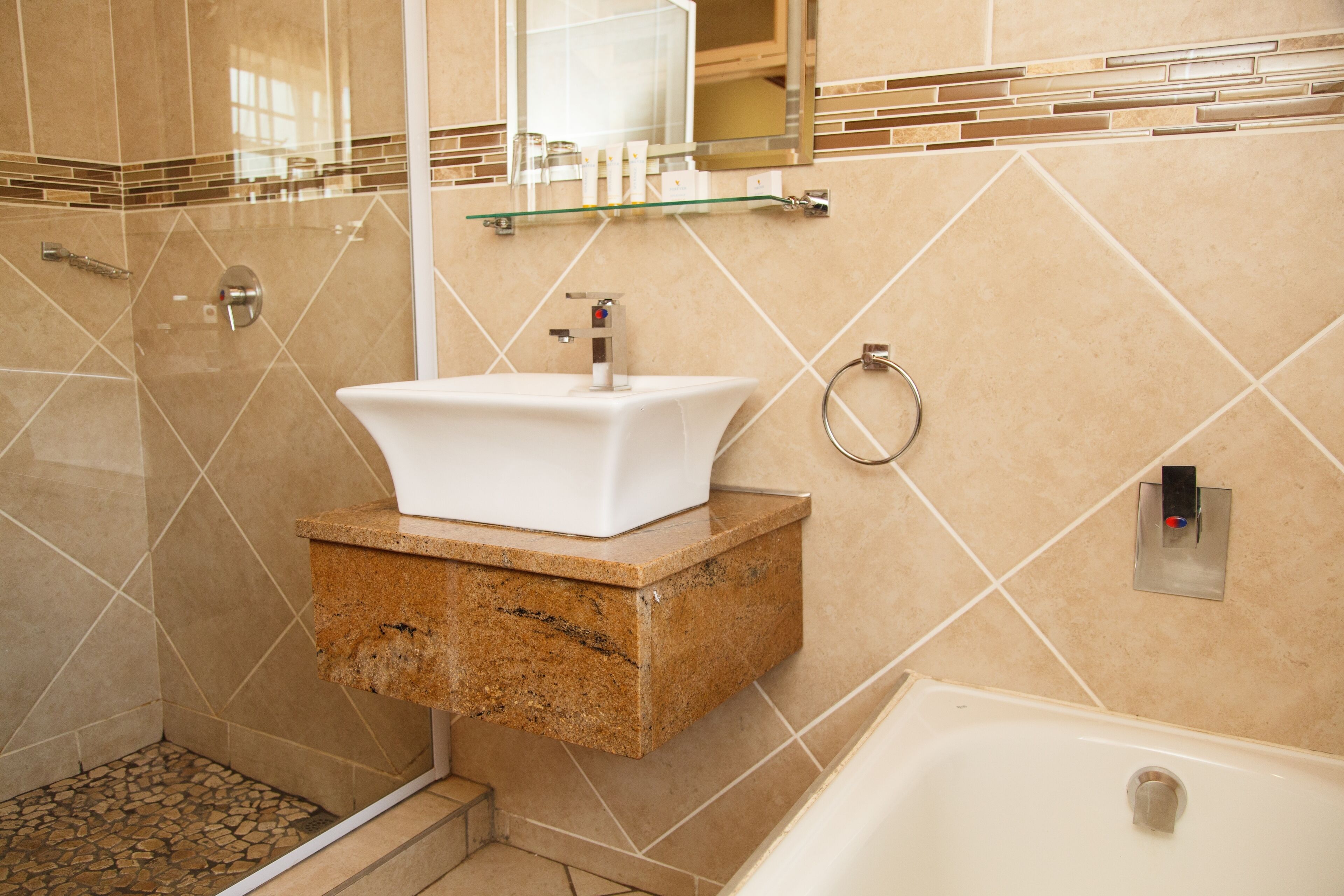 A bathroom with a sink, shower, and bathtub.