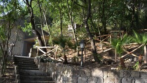 A stone staircase leading up to a building with a wooden fence and trees. - Holiday Time Sorrento (Piano di Sorrento)