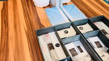 A wooden table with a blue tray containing various skincare products.