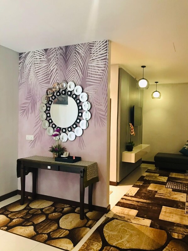 Un interior moderno con un espejo decorativo, una consola y un suelo estampado.
