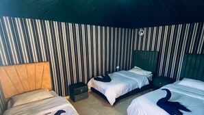 A room with three beds, each with a unique headboard design. - Sand Rose Camp - Hillawi Camp (Wadi Rum)