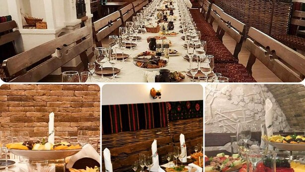 A long dining table set with multiple courses, surrounded by wooden benches. - Astoria (Chisinau)