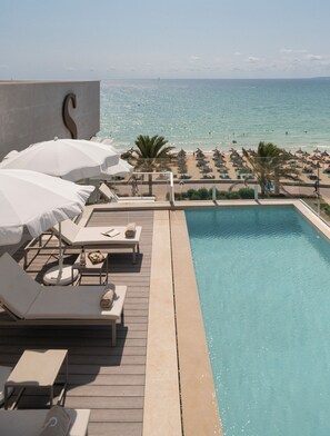 Seasonal outdoor pool, open 10:00 AM to 8:00 PM, pool umbrellas