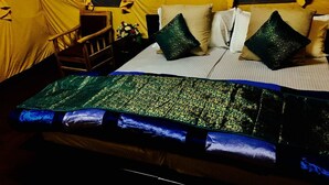 A room with a bed, pillows, and a wooden chair. - D Camp (Leh)